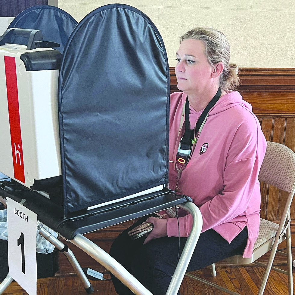 Candy Balliew reads through amendment summaries before casting her votes during the first day of early voting on Monday. In-person early voting will end Nov. 3. Melinda Lucas / Albany News