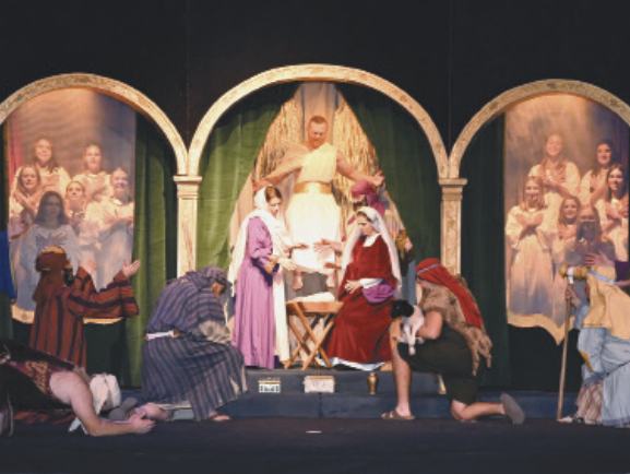 Cast members of the Albany Nativity gather for the final scene, celebrating the birth of Jesus.