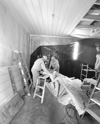Mission team members John Ross Reames (l) and Kyle Viertel (r) measure and cut insulation for a new bunkroom converted from a storeroom in Del Rio’s Young Living Stones Ministries. Another mission team spent the week in Guatemala. Courtesy Photo