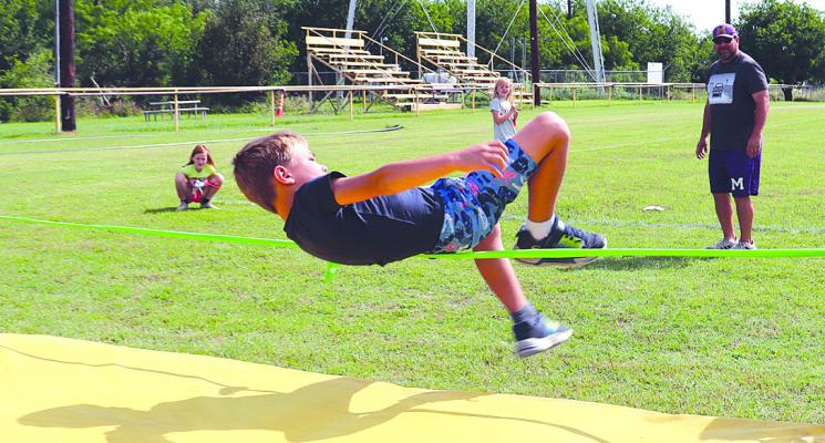 Moran second grader Myles Sebree works to clear the high jump bar during the elementary school field day last week. MISD students have been involved in a long list of end-of-school activities. Photo Provided By Moran School