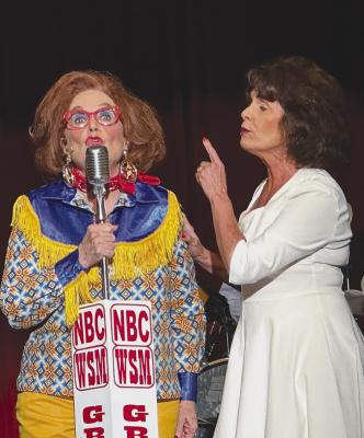 Lorna Ayers (r) as Patsy Cline encourages her biggest fan Louise, played by Pam Davis (l) to sing into the mic. A revival of Always...Patsy Cline played to enthusiastic audiences at the Aztec Theater over the past two weekends. Photo By Watt Casey