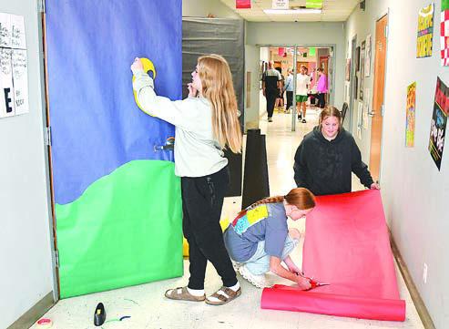 Eighth graders (l-r) Kenzee Roysdon, Tinley Hefner, and Sawyer Shoaf get started on the junior high classroom door that they and other second period classmates have planned for Red Ribbon Week. The 2024 event is set for Oct. 28-Nov. 1. Donnie Lucas / Albany News