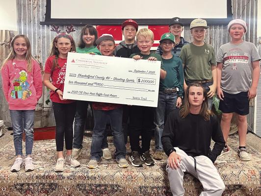 Participants in Shackelford County 4-H Shooting Sports accept a donation this week from Commercial Insurance Solutions and Justin Trail designated specifically for the program. The $2,000 “check,” proceeds from an annual dove hunt and raffle fundraiser, was presented during Monday night’s 4-H Christmas party at the Feed Store. Other recent 4-H events include a mock Food Challenge over the weekend, with 20-plus team members competing. Courtesy Photo