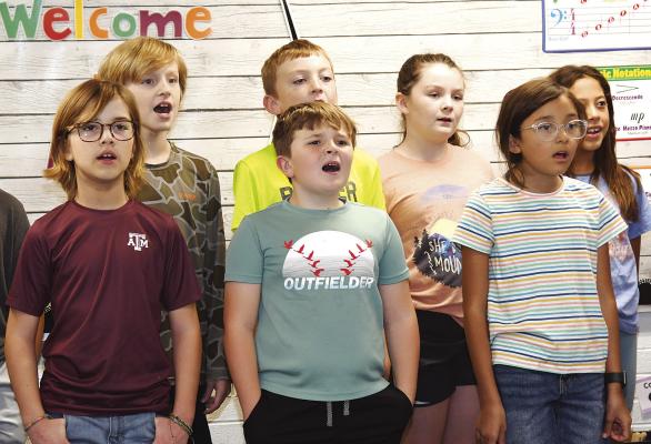 Members of the Nancy Smith Elementary fourth grade class practice a patriotic song for Friday’s program honoring county veterans. The assembly will start at 10:00 a.m. in the AHS main gym. Melinda Lucas / Alba ny News