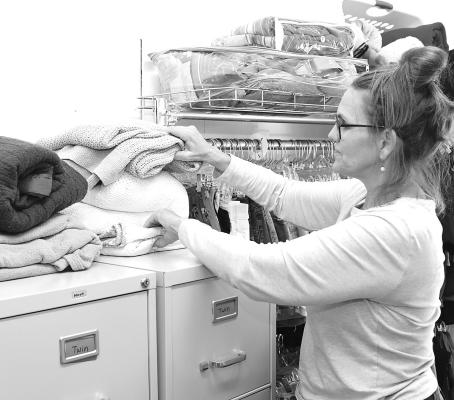Lori Reames counts the available blankets at Closet Angels earlier this week. The local ministry is in need of more blankets and coats as cold weather becomes more likely. Donn ie Lucas / Albany News