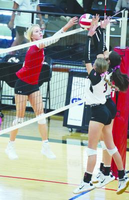 Albany senior Caroline Holson (l) watches carefully as her hit slips over the net, with two Colorado City blockers already in place. The Lady Lions are expected to face Coleman at the bi-district level, with the match to be played in Clyde on Monday. Photo By Julia Vega