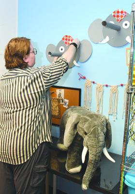 OJAC Student &amp; Teacher Programs Coordinator Dylan Wells prepares a Painted Elephant Ring Toss for the upcoming Cultural Connections Camp featuring Thailand. Other summer workshops include Frontier Days, Things on Strings, OJAC Galaxy, and STEAM OJAC. Donnie Lucas / Albany News