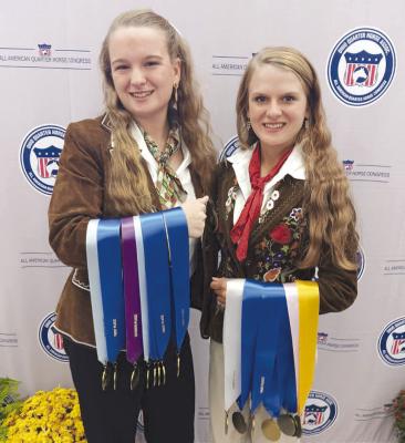 Courtesy Photo Faith Fry (l) and Grace Fry (r) hold the multiple medals they won at the All American Quarter Horse Congress recently in Ohio. The sisters are members of the Shackelford County 4-H club.