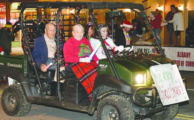 A lighted ATV bearing Art and Betty Viertel, who recently celebrated their 70th anniversary, led about half the 85+ members of their immediate family in an entry that won first place overall in the Chamber Christmas parade. The parade, held last Saturday night, traditionally ushers in the holiday season in Albany. Donnie Lucas / Albany News