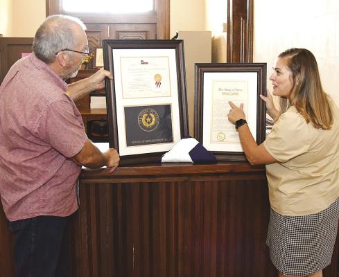 Shackelford 150 committee member Lynsi Musselman (r) shows county judge John Viertel a couple of the framed letters and proclamations that will hopefully be hung in the Courthouse following special activities this weekend. Year-long plans will culminate in the celebration of the 150th anniversary of Shackelford County’s founding. Donnie Lucas / Alba ny News