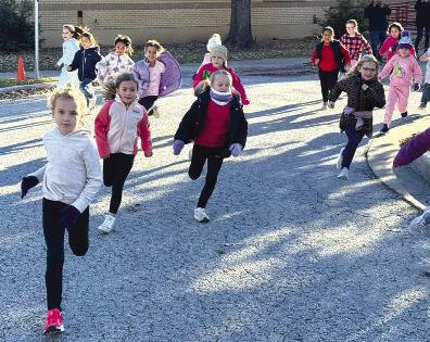 Nancy Smith Elementary students take o! from the starting line during the school’s first Jingle Run, where participants raced for a chance to win turkeys for their families. COURTESY PHOTO
