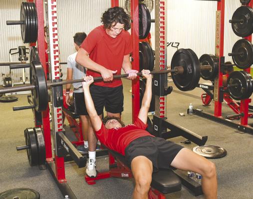 With some spotting help from Hollis Yeates (standing), Jaxson Street gets the weights in position for his workout on Tuesday morning. Junior high and high school boys continued their conditioning program this week, taking a break for a long holiday weekend. Donnie Lucas / Albany News