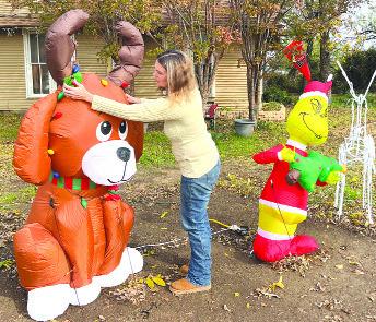 Ti!any Waddell arranges yard decorations for the holiday season. The Albany Chamber is currently requesting nominations for homes to be in the Christmas Decoration Contest. DAVID WALLER / ALBANY NEWS