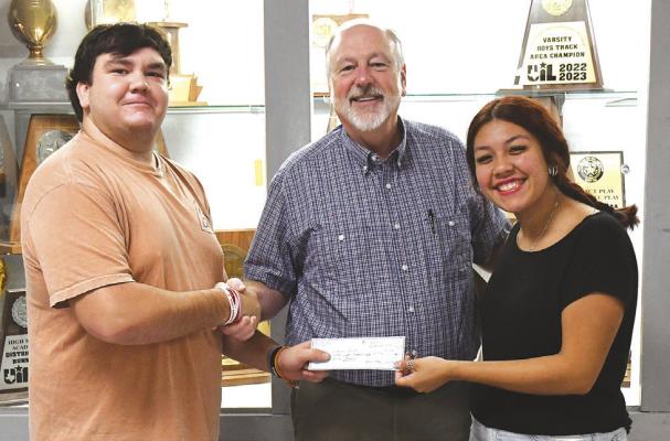 Student council officers Landon Balliew (l) and Gabby Lopez (r) hand over a check for $1,859.75 to Albany Chest board member Robert Dacus (c). The drive set a new record. Donnie Lucas / Albany News