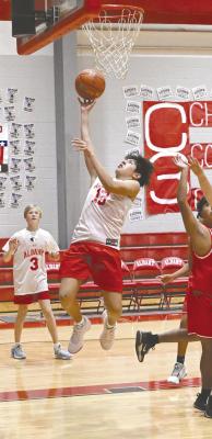 Eighth grader Jathan Perez gets under the basket for a layup during the Albany junior high’s games against Anson on Monday. The local teams won three of their five games. DONNIE LUCAS / ALBANY NEWS