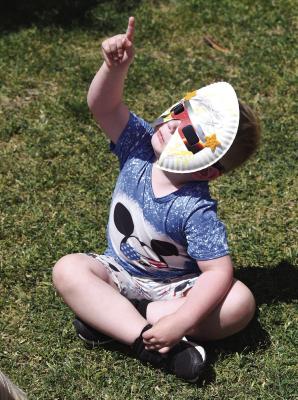 Maddox Putnam, along with other Nancy Smith Elementary students, watches as the moon moves in front of the sun during Monday’s solar eclipse. The Albany PTO provided protective eyewear for all the watchers. Donnie Lucas / Albany News