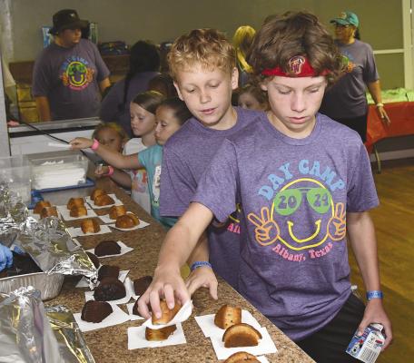Junior high Day Camp volunteers Parker Rose, of Albany, and Chase Funderburg, of Breckenridge, stop for a snack during last year’s camp. Day Camp is one of the organizations receiving funds from the Albany Chest. DONNIE LUCAS / ALBANY NEWS FILE PHOTO