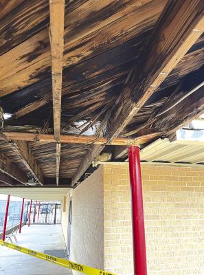 With all the underside material on the elementary’s covered walkway removed, it shows just how extensive the damage is to rafters and decking, caused by ongoing leaks and poor drainage. Repairs are underway on the NSES gym roof and are expected to be completed by mid-January. Courtesy Photo