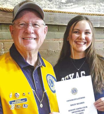 LIONS CLUB OFFICER BOB SKELTON (l) &amp; CLUB SWEETHEART RILEY REAMES (r)