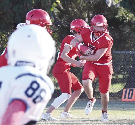 Eighth grader Bennett Neece tucks the ball in and looks for his best route downfield as a combined Cubs team takes the win over TLCA. The game concluded the junior high season. Donn ie Lucas / Albany News