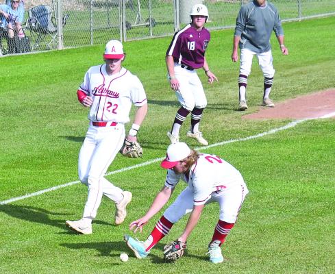 Back up by third baseman Zane Waggoner (l), Cole Read (r) leaves the pitchers mound to scoop up a Hawley bunt. The Lions are 4-2 in district. Donnie Lucas / Albany News