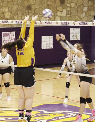 Moran’s Chelsea Thurman (l) blocks a ball during the Lady Bulldogs’ matches against Woodson on Saturday. The girls will play their final game of the season Saturday in Strawn. Photo Provided By Moran School