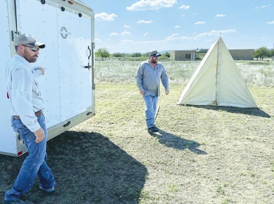 Tanner Brockman (l) and Kris Pattillo (r) at Fort Griffin State Historic Site unload and set up tents that will be used by reenactors this weekend during the annual Living History Days. Albany elementary students will travel the short distance to the park on Friday morning. Photo Provided By Fort Griffin State Historic Site