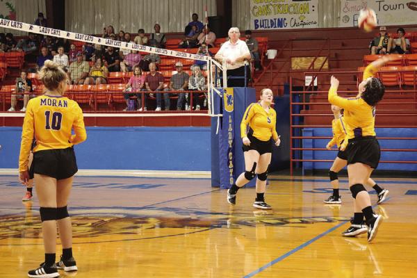Leanna Sikes (r) hits the ball during one of the Lady Bulldogs’ final games of the season. Low numbers forced them to forfeit the last few games of the district schedule. Photo Provided By Moran School
