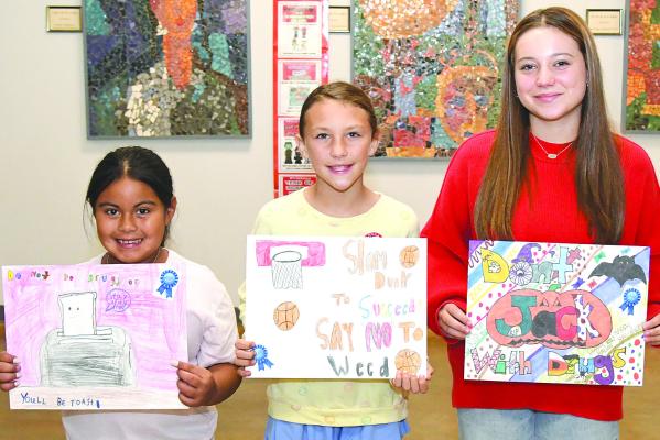 First place winners in the Red Ribbon poster contest held last week at Nancy Smith Elementary include (l-r) Lacey Castille, Kate Bellah, and Madison Swert. There were several other competitions during the Red Ribbon emphasis, including daily dress-up days at the secondary campus, with both student and teacher winners. Junior high and high school classess also competed for an extended lunch period with drug free door decorations. Donn ie Lucas / Albany News