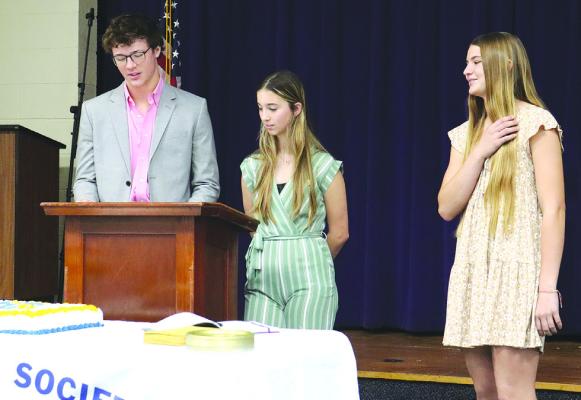 Current Moran National Honor Society members Ellis Hise (l) and Jayla Bussell (c) swear in Bradee Stautzenberger (r) in a ceremony Nov. 1. The event was held in conjunction with the staff development program. Photo Provided By Moran School