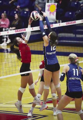 Abi Hale goes head to head with Windthorst’s middle blocker during the Lady Lions’ area loss to the powerhouse defending state champions on Thursday night. Albany had won the bi-district crown against Water Valley in a hard-fought five-set match two nights before. Photo By Julia Vega