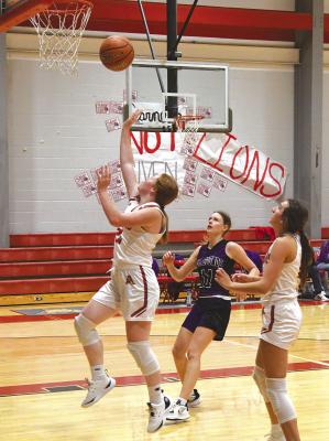 Charli Hefner puts the ball up under the net Tuesday night against Throckmorton. The varsity did not play because of illness.