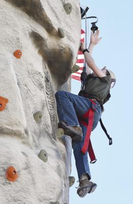 Ayers Bezner rings the bell at the top of the climbing tower, one of three new attractions at the PTO’s annual Fall Fest. The 2023 event was deemed the “most profitable” to date. Donn ie Lucas / Albany News