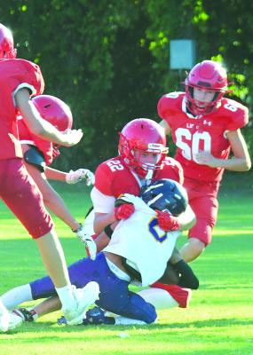 With Albany players closing in on all sides, Sam Tidwell (c) gets to the Merkel quarterback first to take him down for a sack in the eighth grade’s 48-6 win. The Cubs will be in Anson today. Donnie Lucas / Albany News