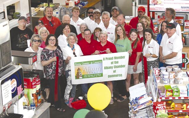 Members of the Chamber of Commerce, along with well-wishers, help Prairie Star staff and vendors celebrate at an open house and official Chamber ribbon cutting on June 22. The convenience store and deli reopened a couple of months ago with new ownership after being closed for about a year for remodeling and reorganization. Melinda Lucas / Albany News