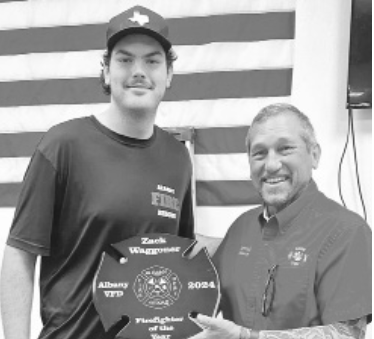 Fire Chief Joel Viertel presents the ‘Firefighter of the Year’ plaque to Zack Waggoner during the Albany Volunteer Fire Department’s annual awards presentation.